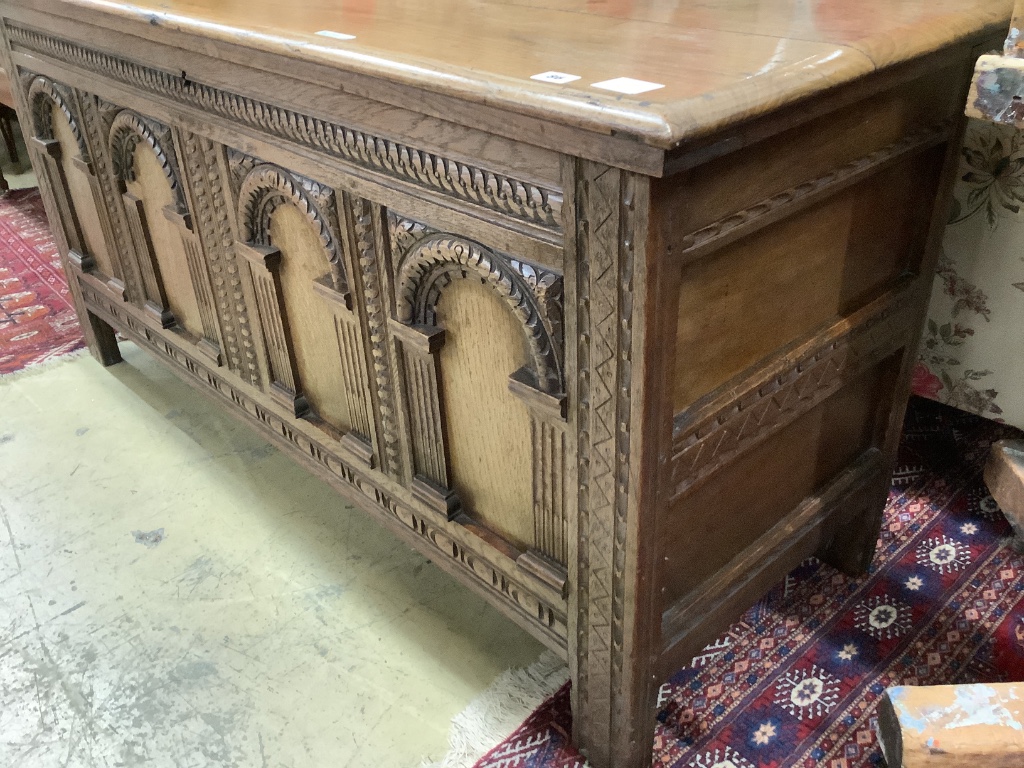 An 18th century and later oak coffer with arch panelled front, width 142cm depth 52cm height 68cm